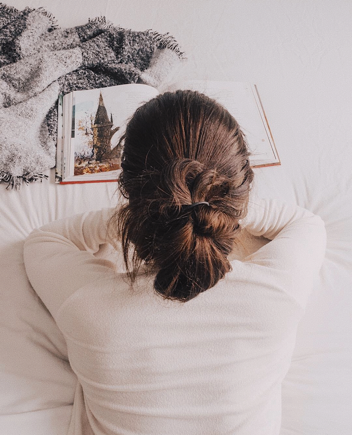 Overhead view of a woman reading a book, used as the category image for favorite books on the homepage.